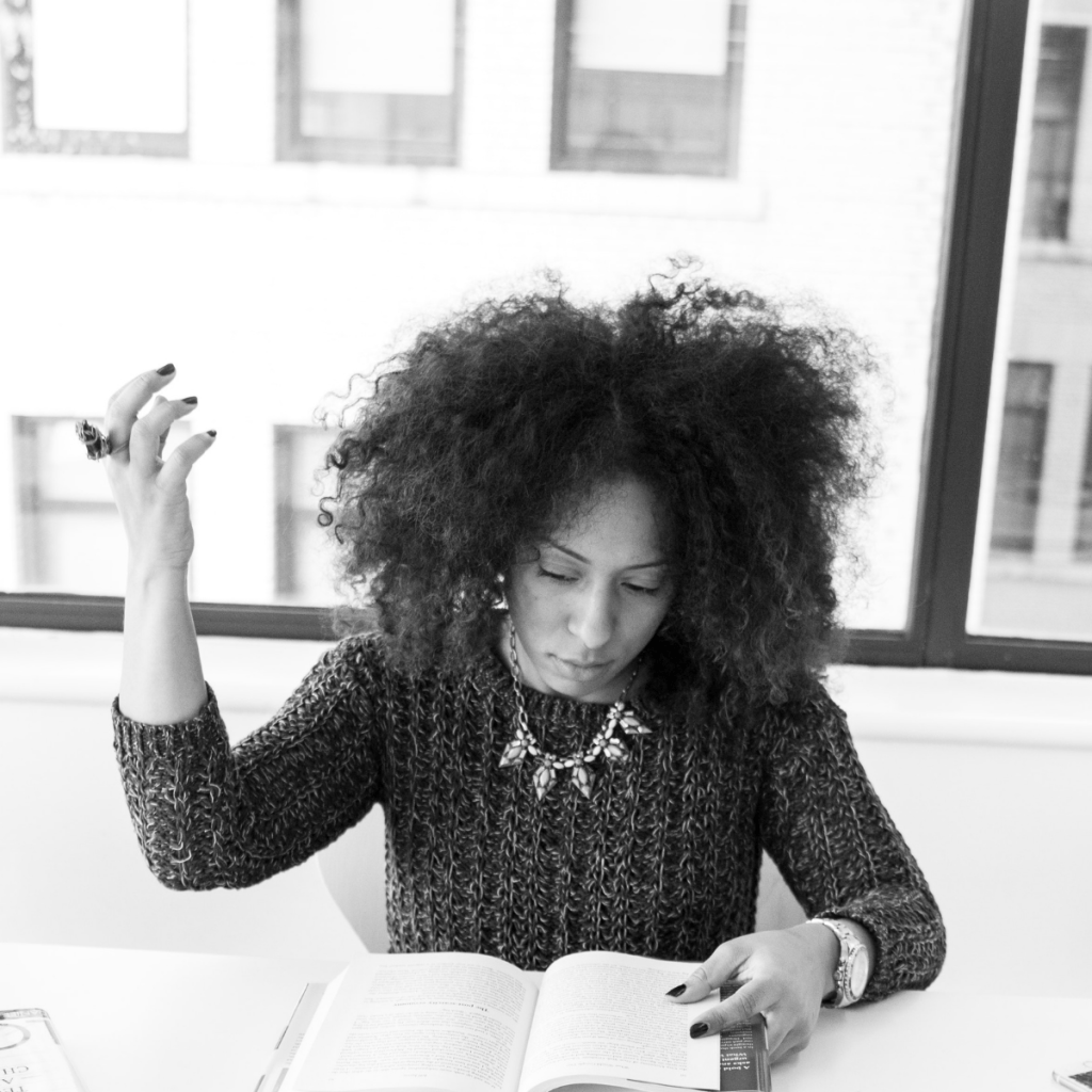 Greyscale photo of woman reading